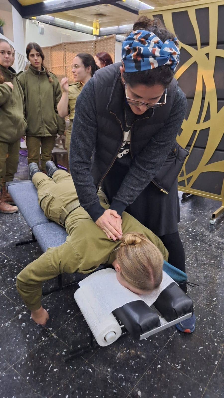 Dr. Raimi Tuchinsky treating a soldier on a portable table during an IDF volunteering session